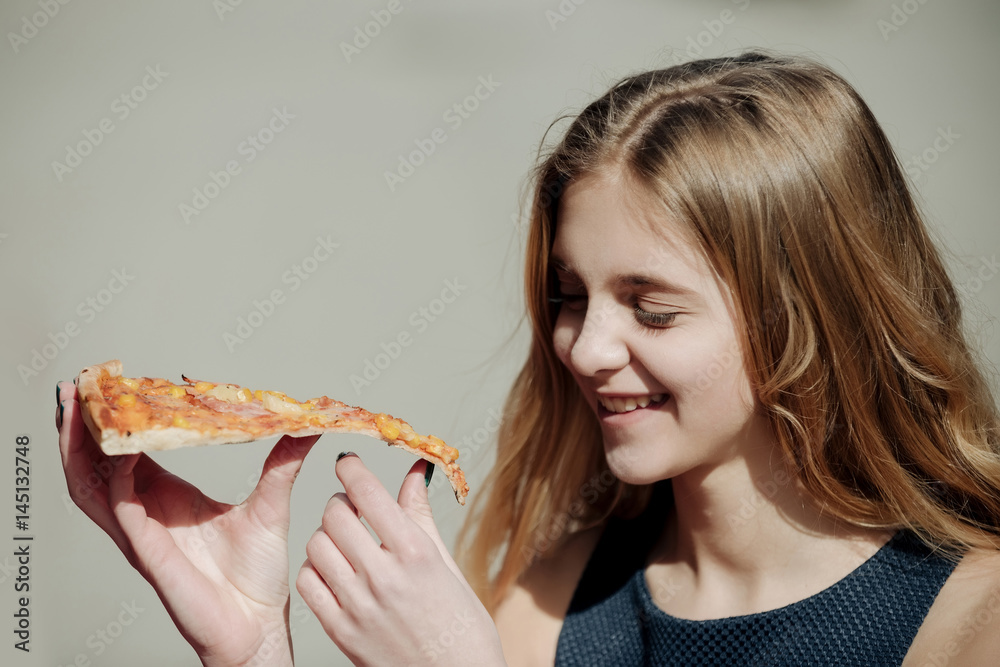 Happy pretty girl smiling with piece of tasty pizza Happy pretty girl smiling with piece of tasty pizza