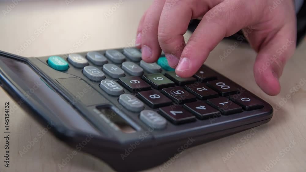 A businessman is feeling so angry after calculating something and he hits with his fist on a device. A businessman is feeling so angry after calculating something and he hits with his fist on a device.