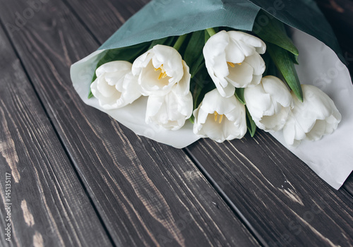 Mother s Day . white tulips on dark  wooden background