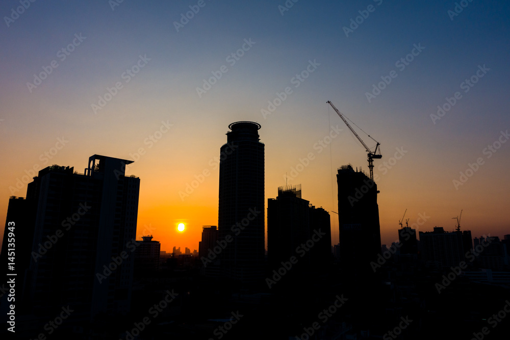 Silhouette buildings when sunset