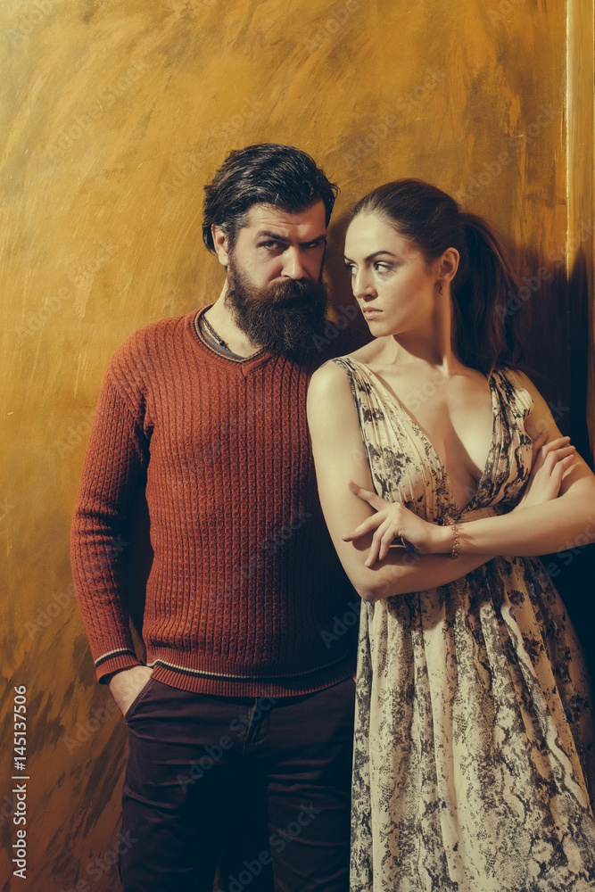 Pretty girl and serious bearded man with beard