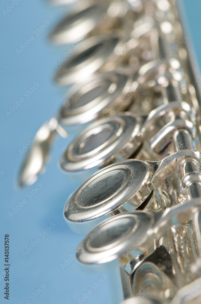 Fototapeta premium Macro shot of flute keys on blue with a shallow depth of field