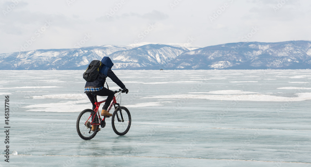 Baikal lake, Russia, March 12, 2016.tourists on bikes traveling on the frozen Lake Baikal, Russia Baikal lake, Russia, March 12, 2016.tourists on bikes traveling on the frozen Lake Baikal, Russia