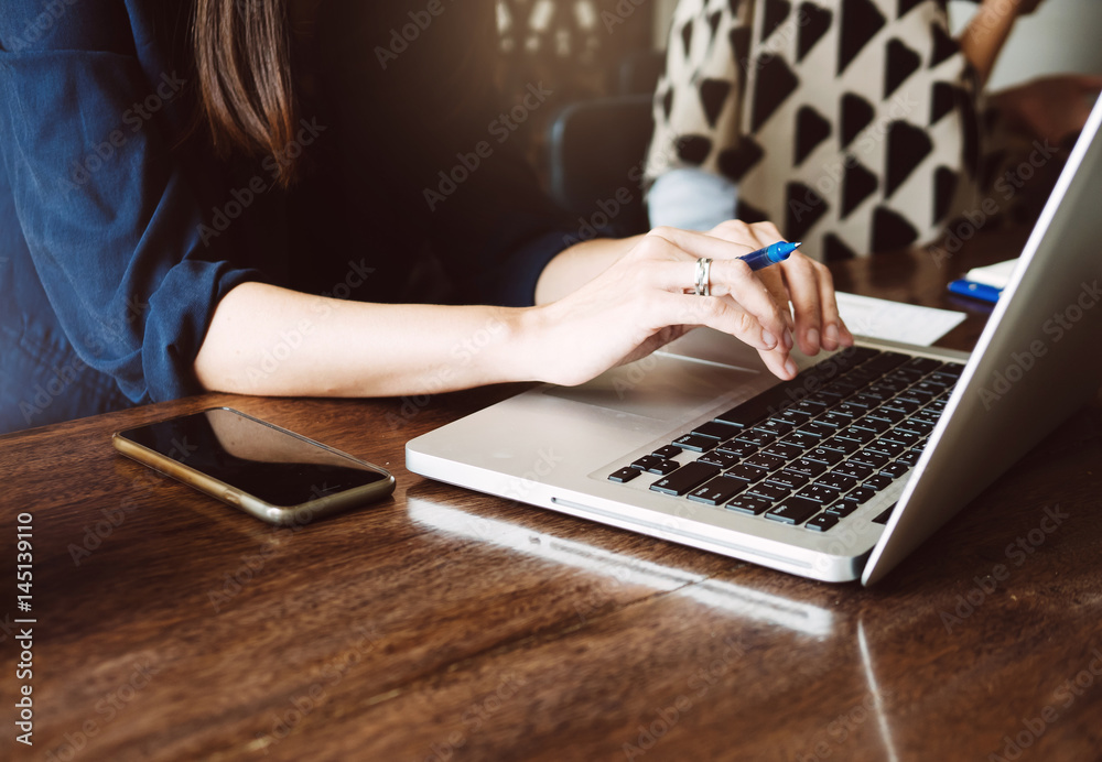 Typing on laptop computer in a home office, working, selective focus