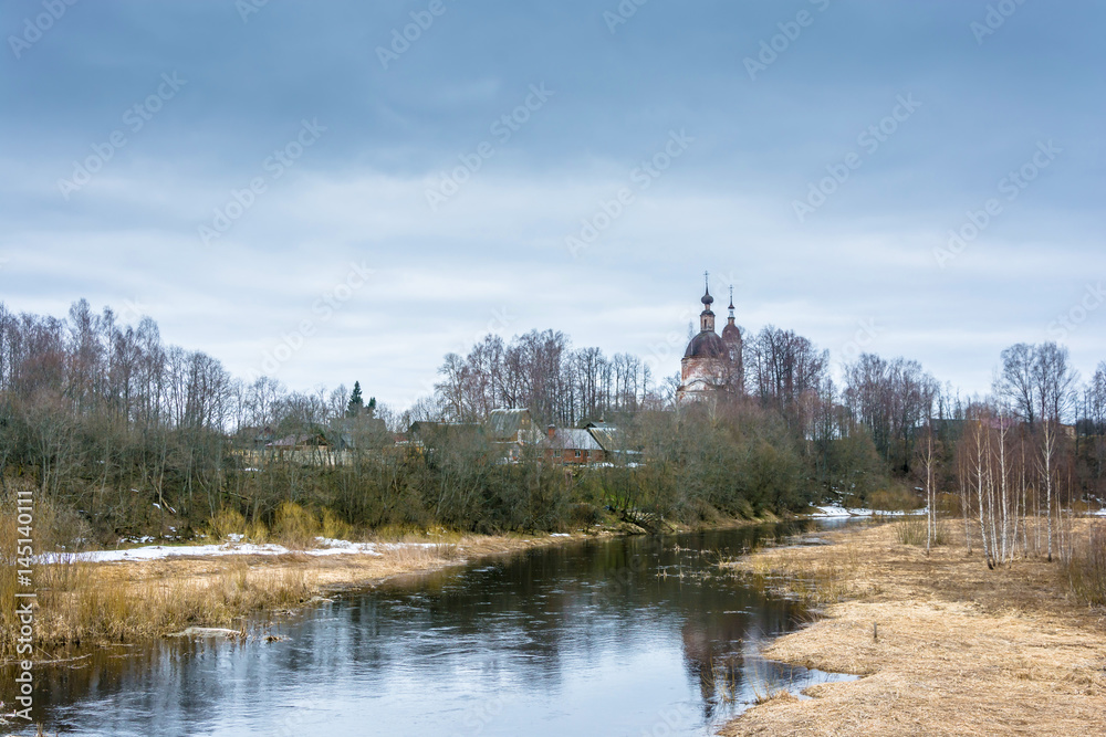 The old brick Church on the banks of a small river.