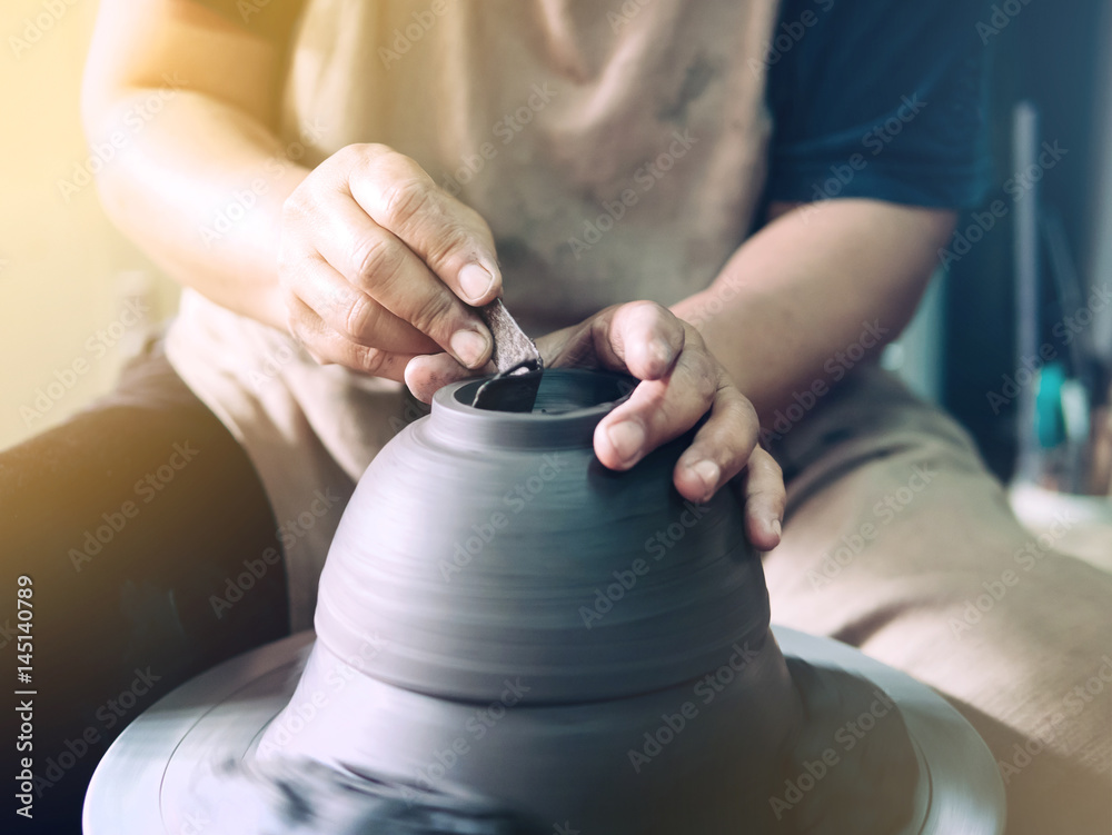 Potter making a clay pot, handmade, selective focus