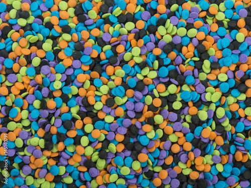 Halloween colored candy sprinkles background texture