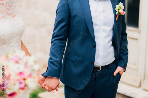 Bride and groom holding hands. Wedding in Montenegro