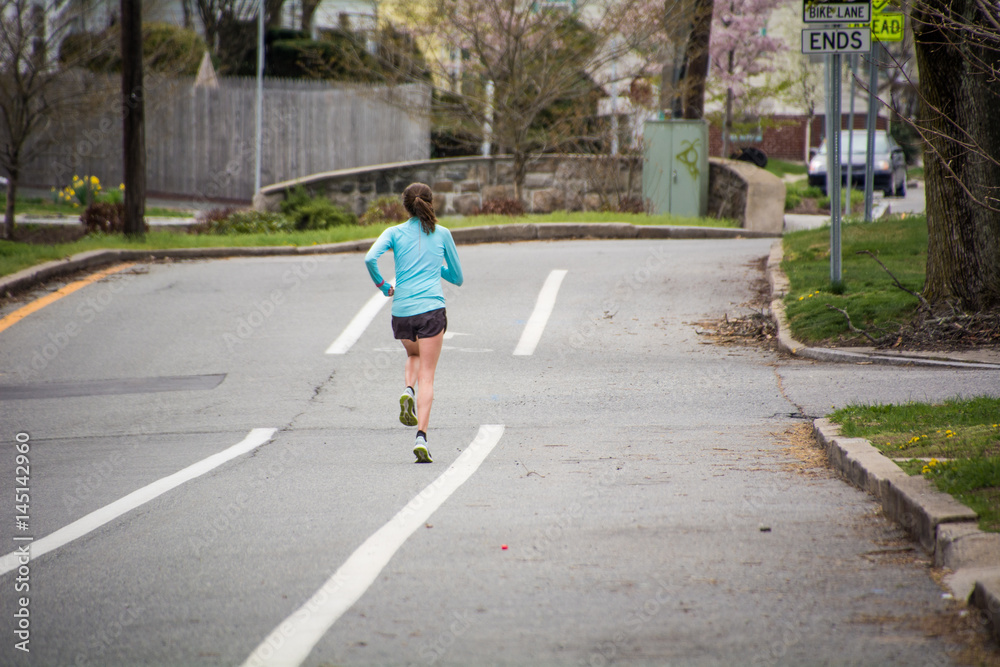 Lone jogger in a bike lane. Lone jogger in a bike lane.