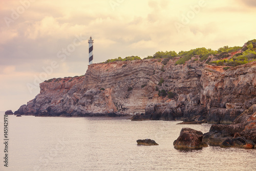 View of the Moscarter lighthouse on the northwest coast of the island of Ibiza, Spain photo