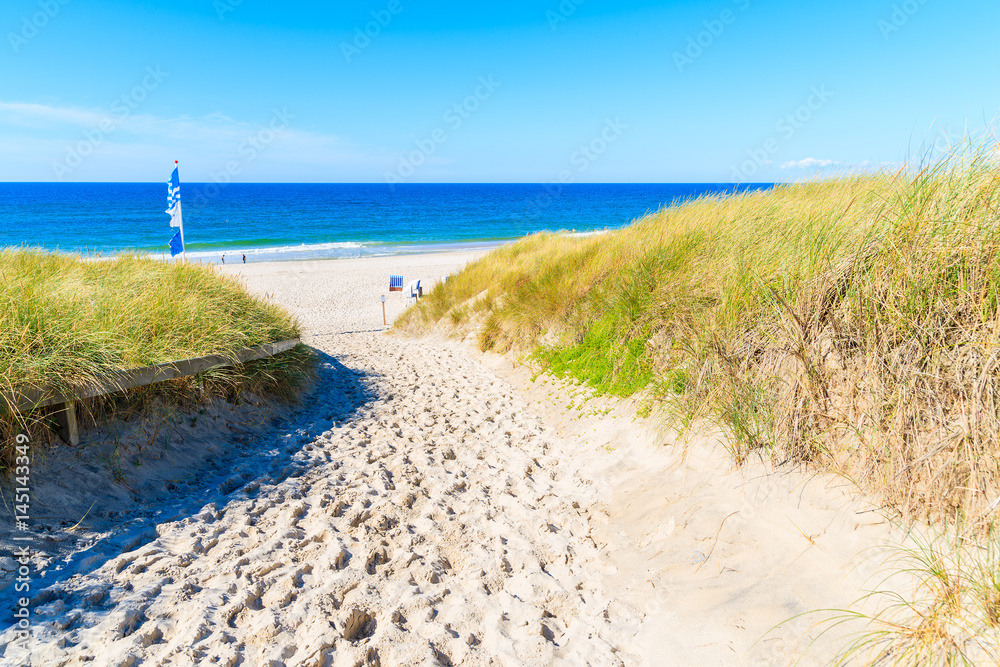 Entrance to sandy beach in Kampen village on Sylt island, Germany Entrance to sandy beach in Kampen village on Sylt island, Germany
