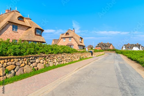 Typical Frisian red brick houses with straw roofs in Rantum village on southern coast of Sylt island, Germany photo