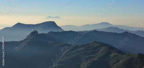 Early morning in the Annapurna Conservation Area, Nepal. View from Ghale Gaun. Hills covered by forest and valleys.