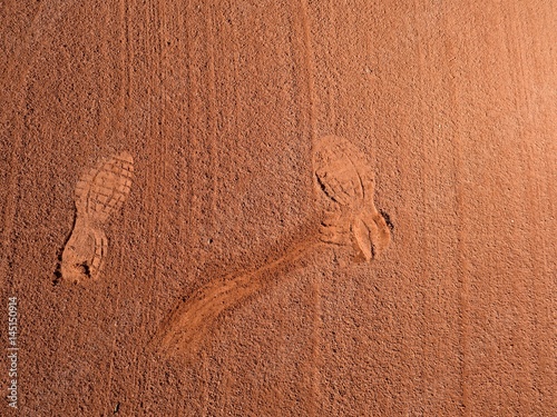 Detail with a sport shoe footprint on a tennis clay court photo