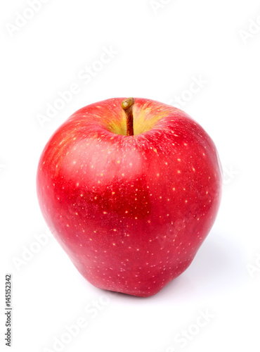 Red Apple lies vertically close-up isolated.