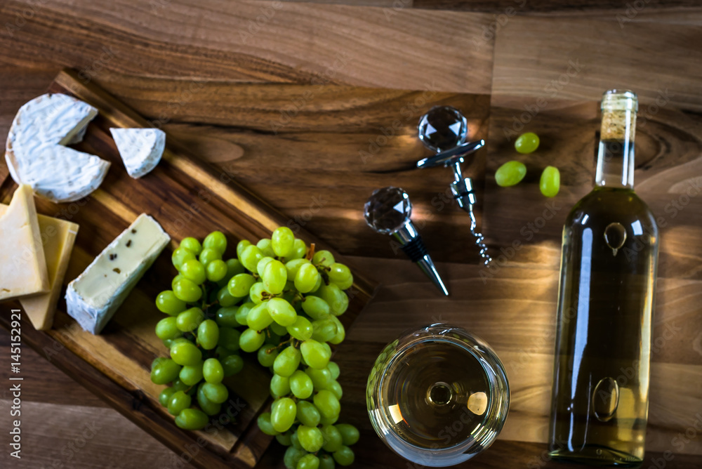 Obraz premium Wine bottles with grapes and cheese on wooden rustic background. copy space