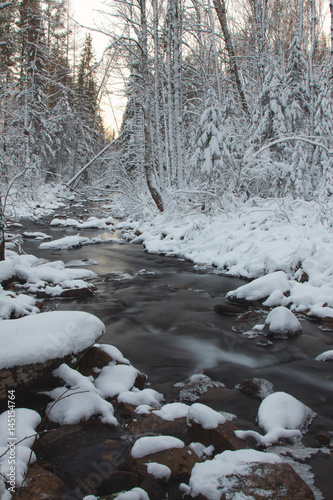 River in snowy forest. © esalienko