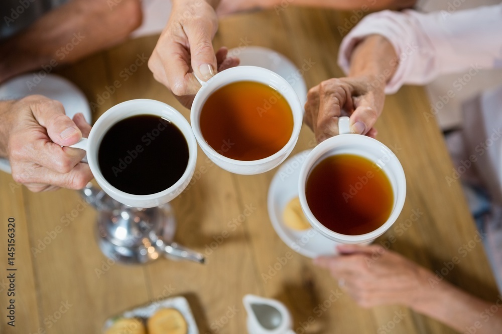 Group of senior friends toasting coffee cups Group of senior friends toasting coffee cups