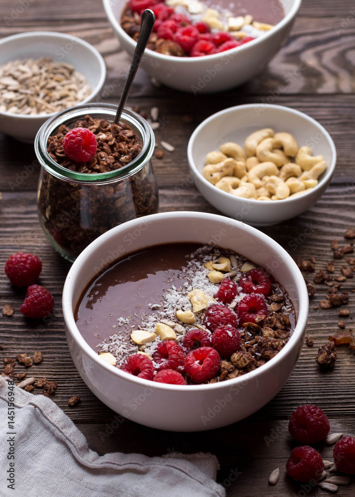 Breakfast bowls with frozen banana, raspberries, cocoa powder, nuts and coconut Breakfast bowls with frozen banana, raspberries, cocoa powder, nuts and coconut
