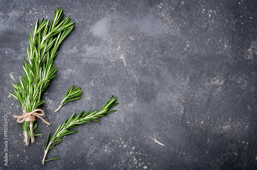 Rosemary on dark background. Herbs and spices. Top view and copy space for your recipe