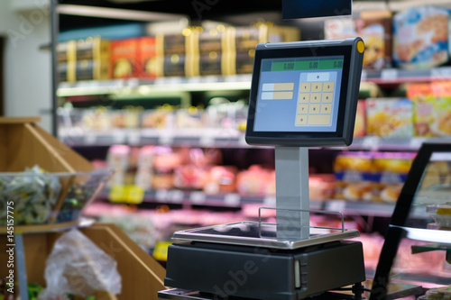 Digital scales with screen for product weighting in modern supermarket