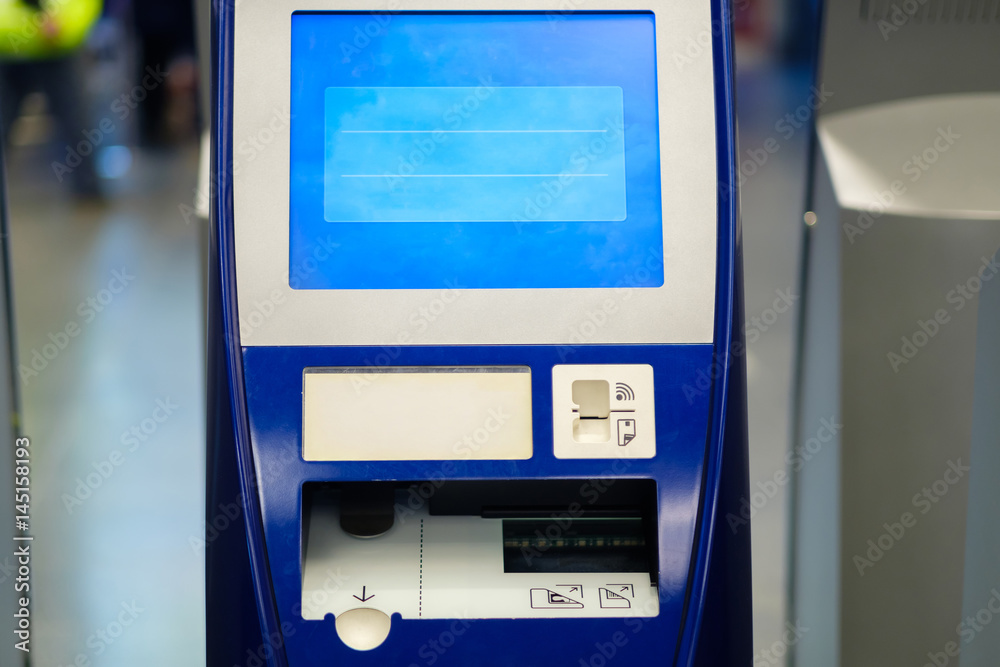 Self check in terminals in hall of airport Self check in terminals in hall of airport