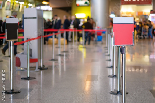 Waiting lines and information labels in front of check-in desks in airport