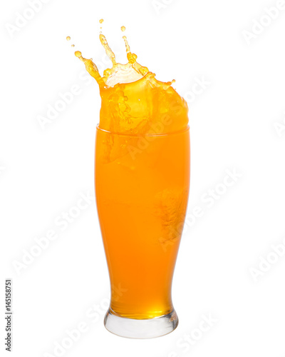 Orange juice splashing out of glass isolated on white background.