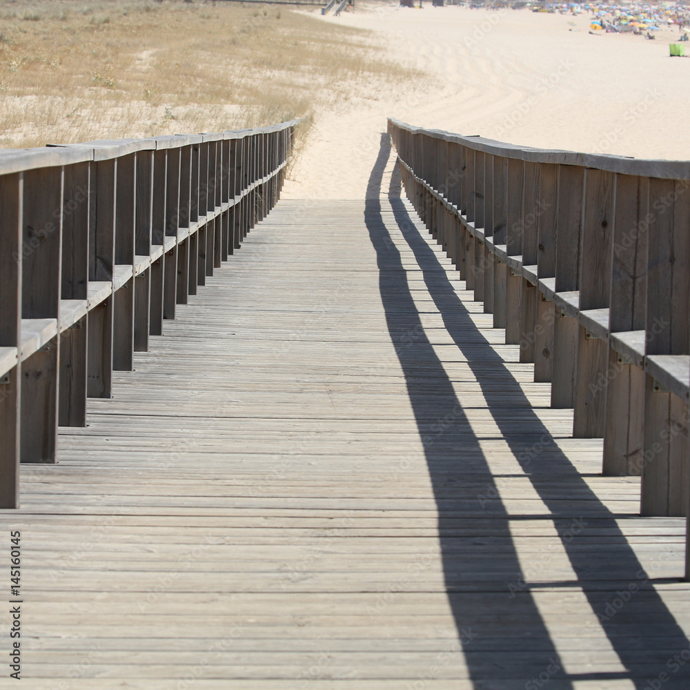 wooden walking path at the beach.
