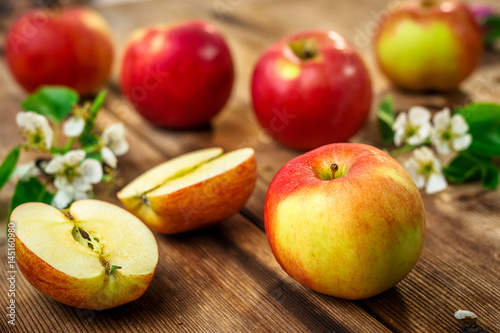 Raw organic apples on wooden background
