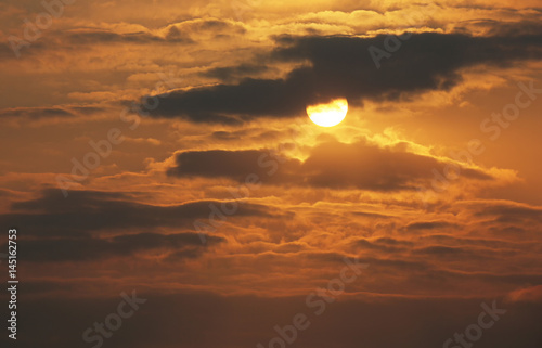 Brilliant orange sunrise over clouds. © LeitnerR