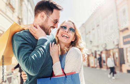 Shopping time. Beautiful couple in shopping. Consumerism, shopping, lifestyle, fashion