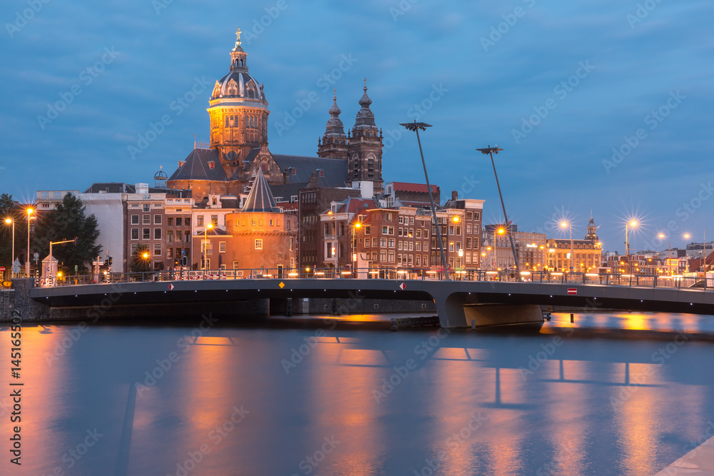 Obraz premium Night city view of Amsterdam canal, bridge and Basilica of Saint Nicholas, Holland, Netherlands. Long exposure