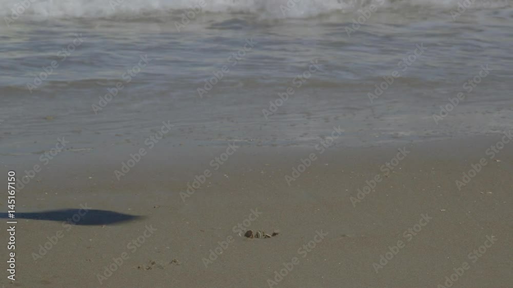 Building Small Sandcastles with Ocean Waves Crashing on the Beach Building Small Sandcastles with Ocean Waves Crashing on the Beach