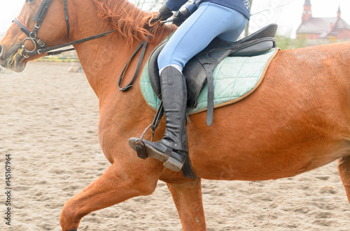 A rider on horseback overcomes obstacles.