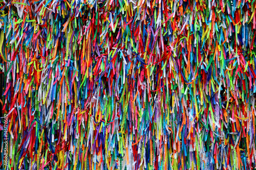 Colorful ribbons in front of a catholic church called Senhor do Bonfim in Salvador, Bahia in Brazil. Famous touristic place where people make wishes while tie the ribbons in the Carnival land.