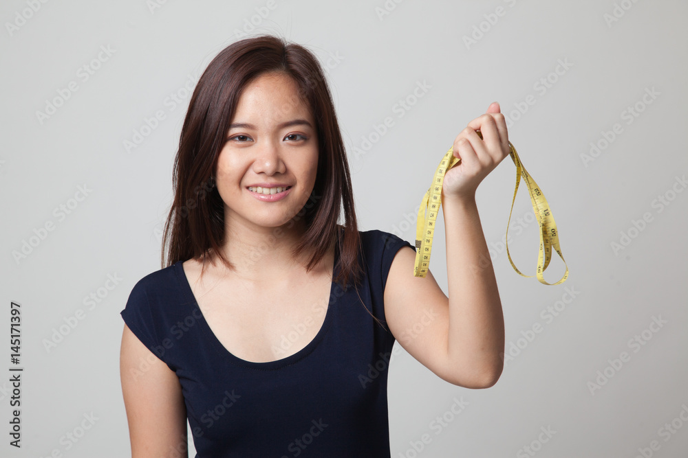 Young Asian woman with measuring tape. Young Asian woman with measuring tape.