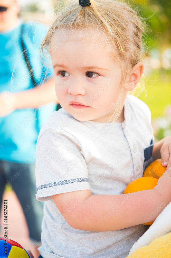 small baby boy with orange fruit sunny outdoor small baby boy with orange fruit sunny outdoor