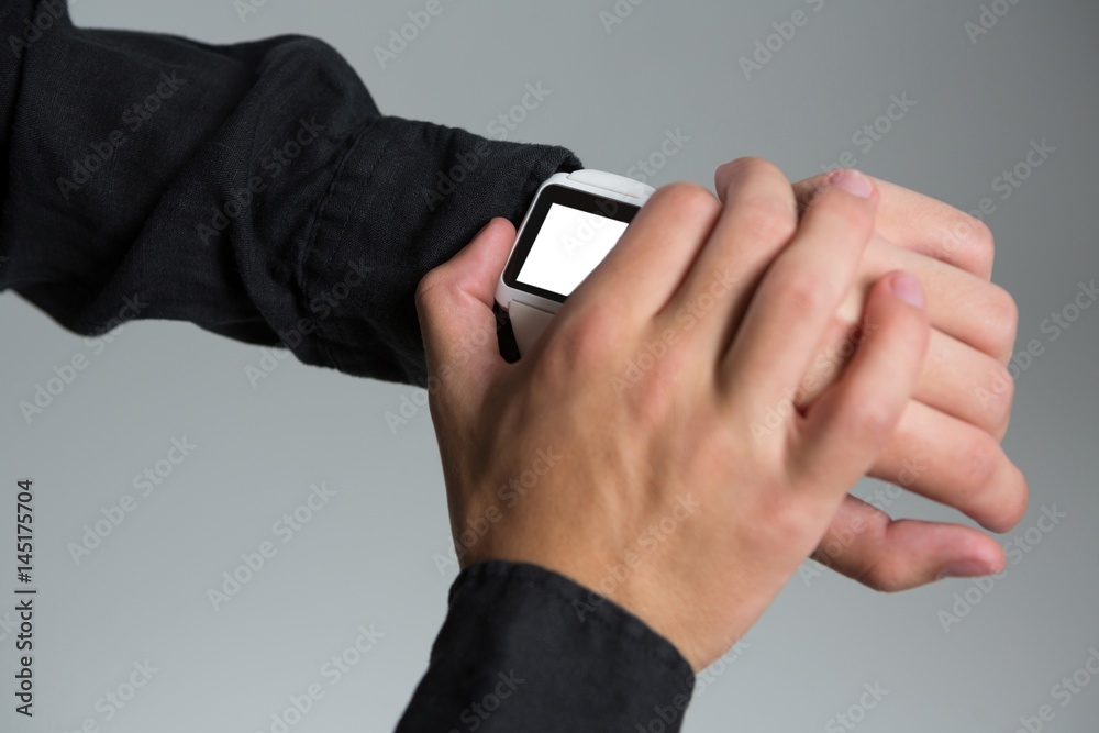 Androgynous man using smart watch Androgynous man using smart watch