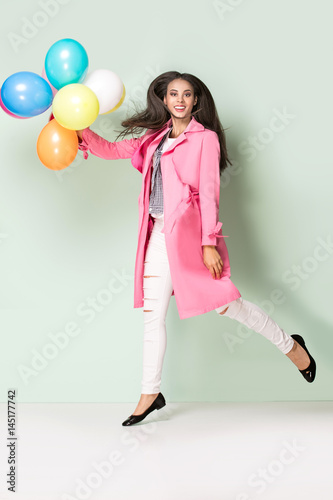 Happy young woman with balloons. © neonshot