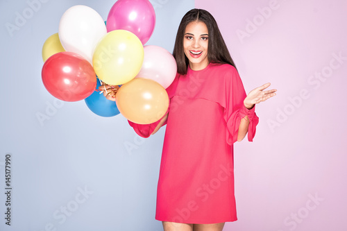 Smiling african american girl with balloons.