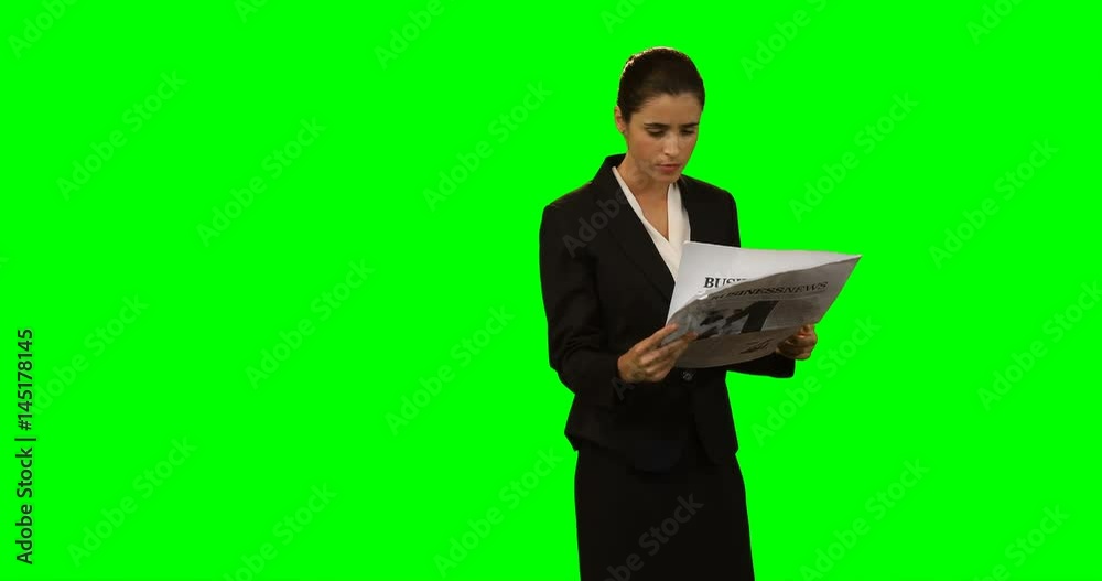 Businesswoman reading newspaper Businesswoman reading newspaper