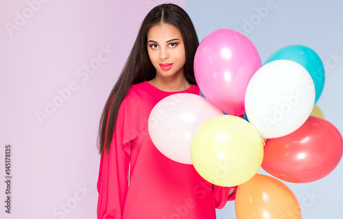 Happy young woman with balloons.