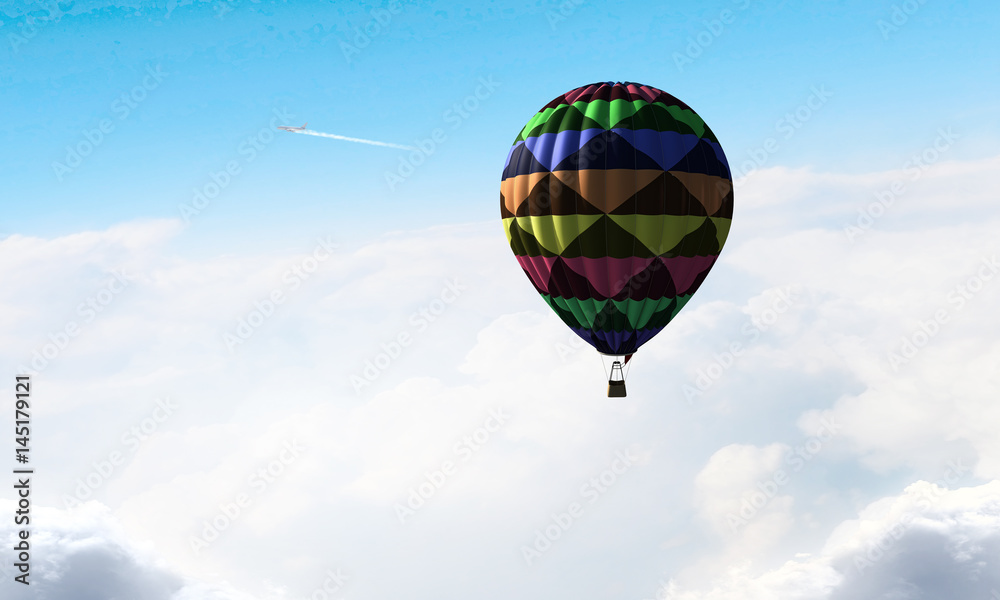 Fototapeta premium Aerostat flying above clouds . Mixed media