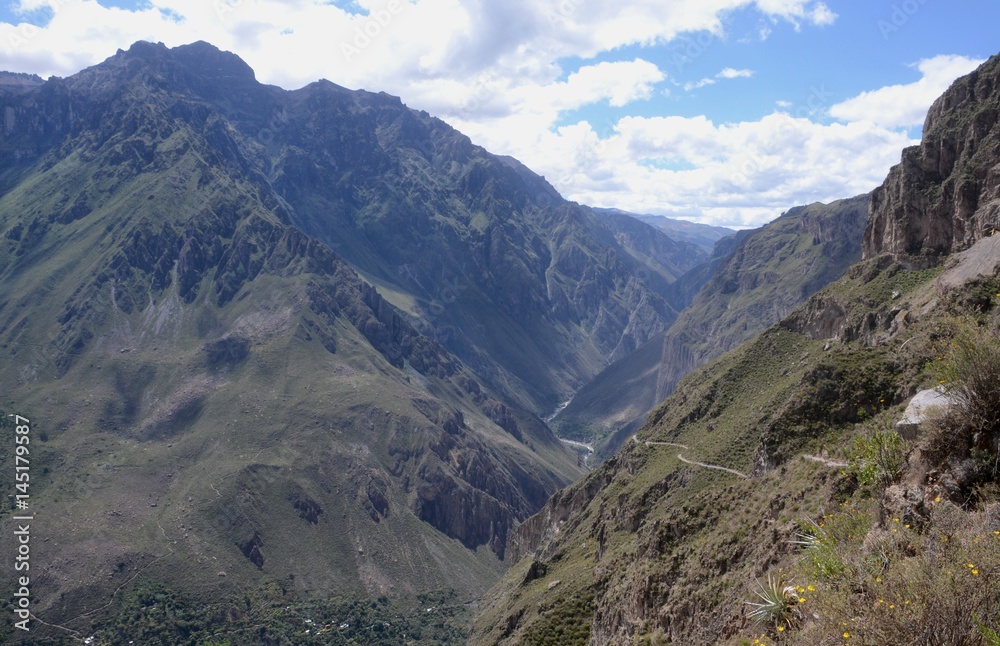 Fototapeta premium Hiking trail through the Andean mountains surrounding the stunning and massive Colca Canyon in Southern Peru
