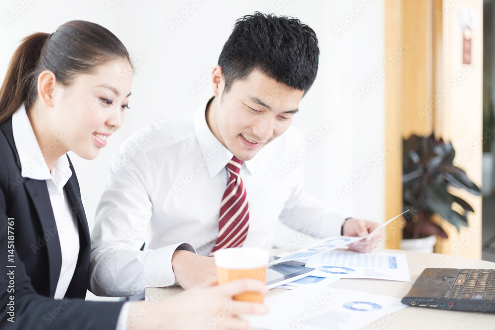 young asian businessman and businesswoman in modern office young asian businessman and businesswoman in modern office