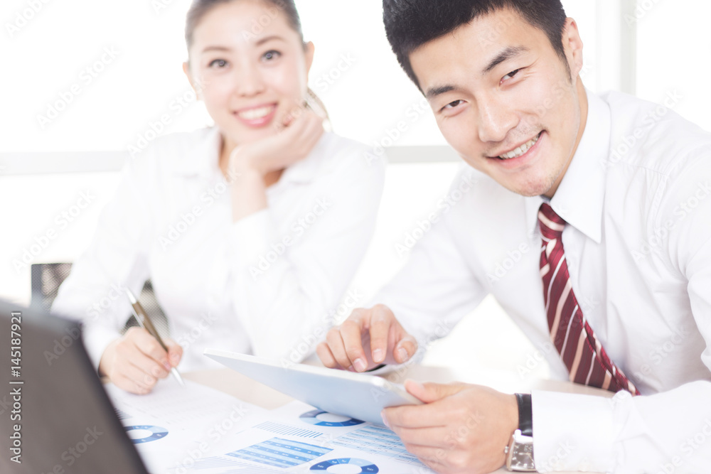 Fototapeta premium young asian businessman and businesswoman in modern office