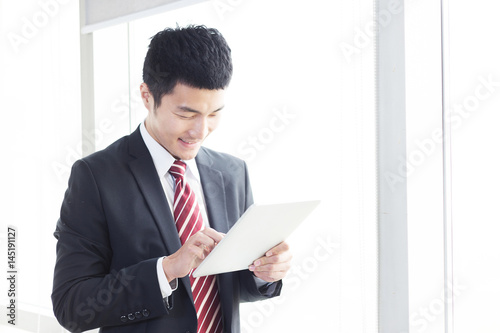young chinese business man in modern office