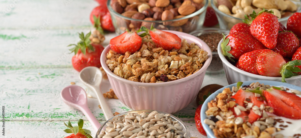 Muesli, nuts, yogurt and cereals on a white background