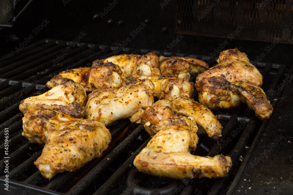 Side view of seasoned barbecued chicken wings golden brown Side view of seasoned barbecued chicken wings golden brown